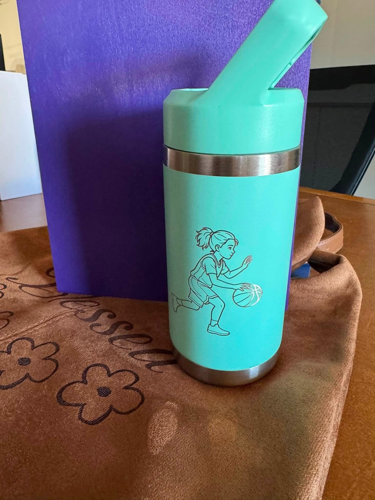 Turquoise personalized sports bottle engraved with a basketball player